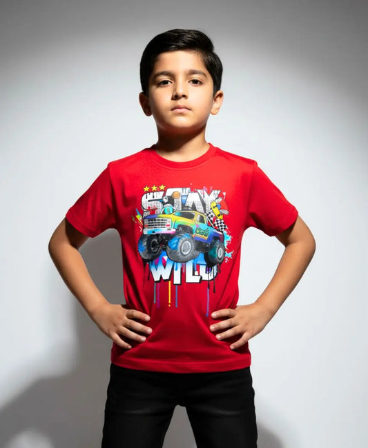 Child wearing a red t-shirt with a colorful graphic design on a plain background