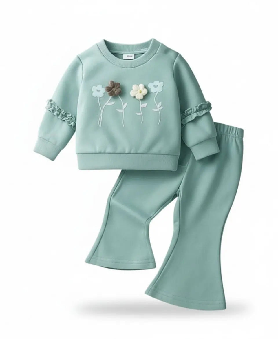 Teal children's outfit with floral embroidery on a white background