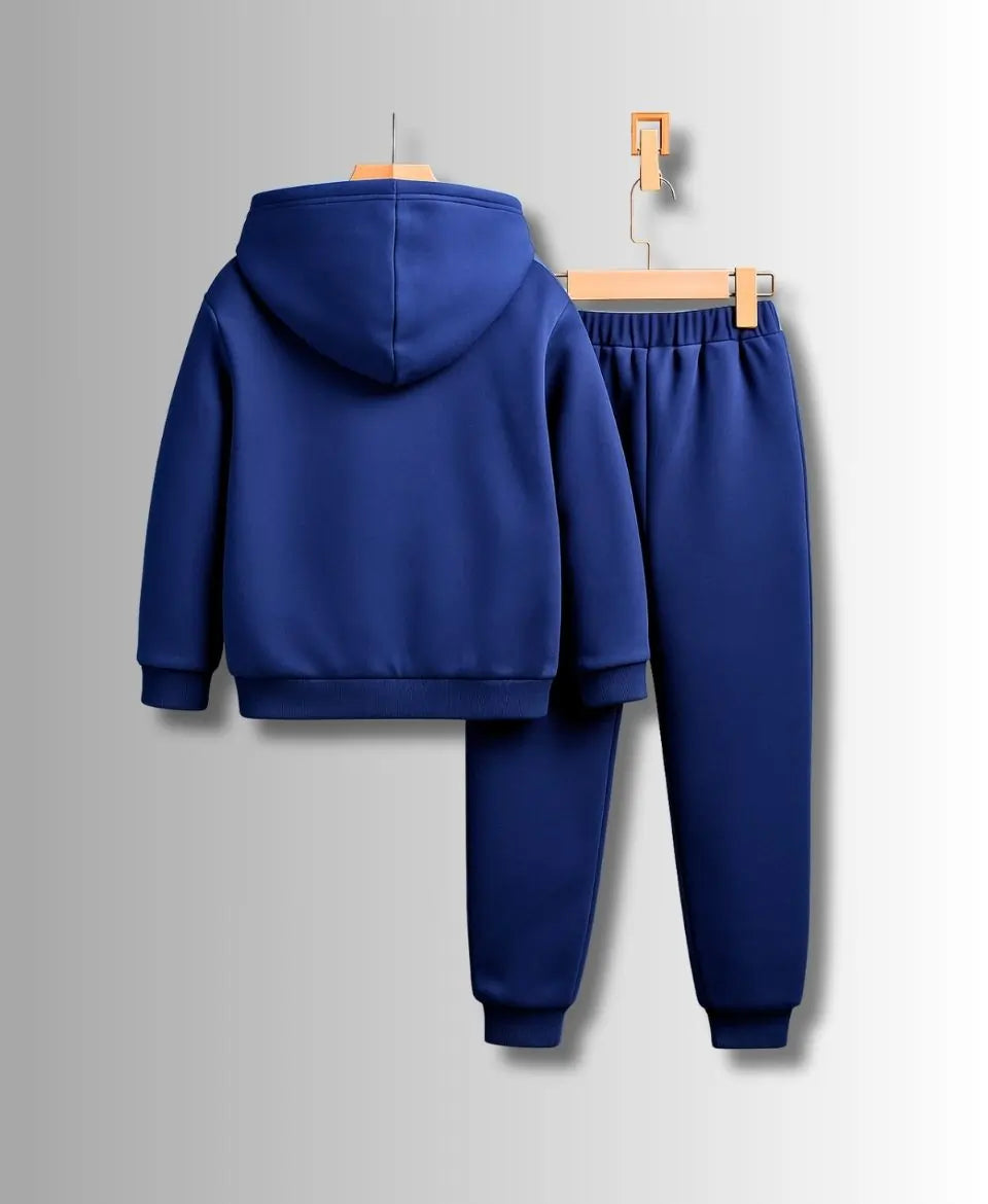 Blue tracksuit on hangers against a gray background