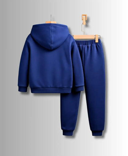 Blue tracksuit on hangers against a gray background