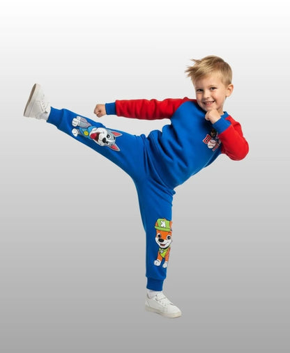 Child wearing a blue and red outfit with cartoon character designs on a gray background