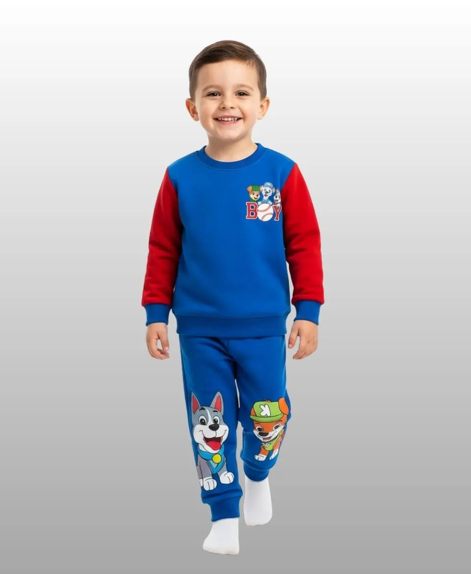 Child wearing a blue and red pajama set with cartoon characters on a white background