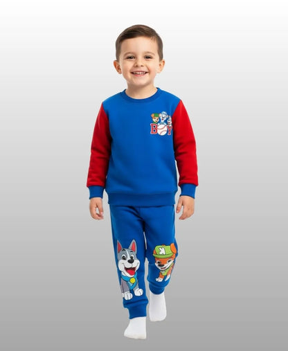 Child wearing a blue and red pajama set with cartoon characters on a white background