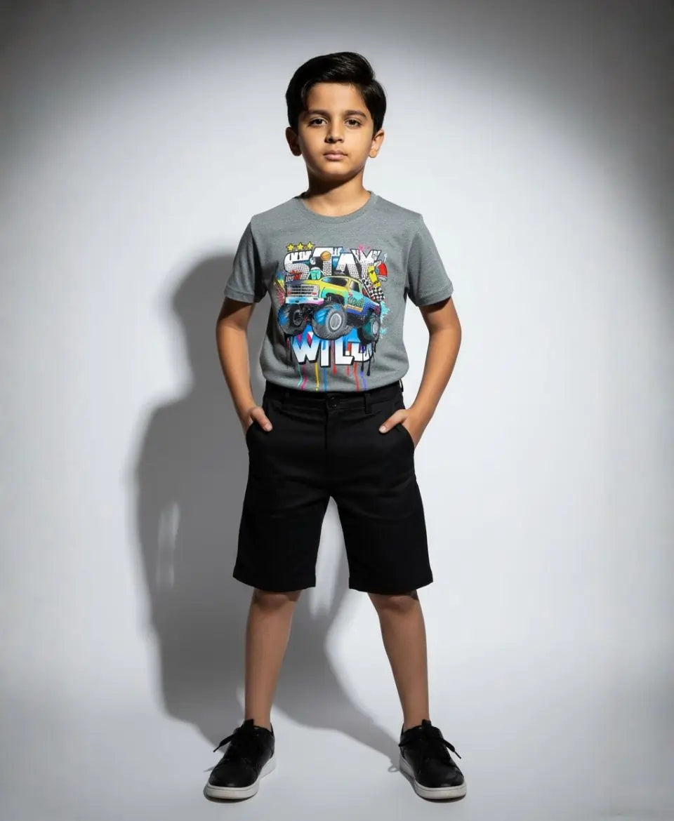 Child wearing a gray t-shirt with colorful graphics and text, standing against a plain background