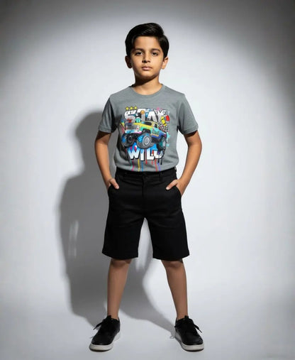 Child wearing a gray t-shirt with colorful graphics and text, standing against a plain background