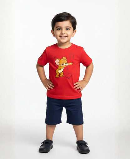 Child wearing a red t-shirt with a cartoon character and navy shorts on a white background