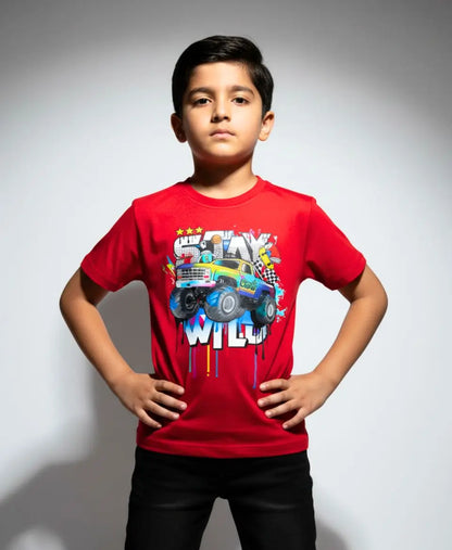 Child wearing a red t-shirt with a colorful graphic design on a plain background