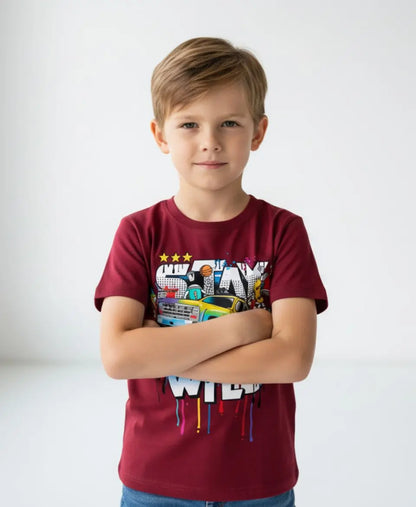 Child wearing a red t-shirt with colorful graphics on a white background