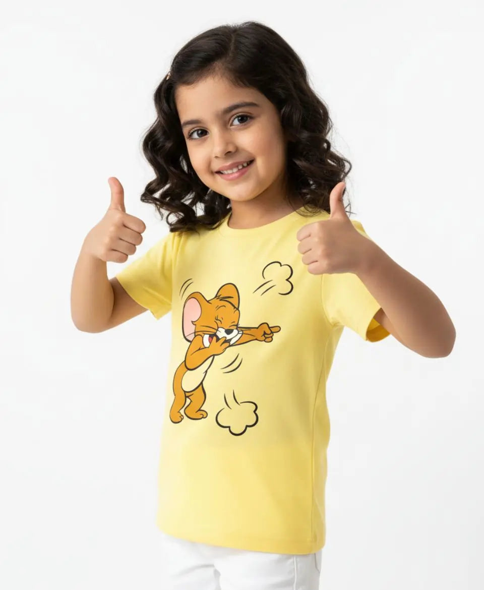 Child wearing a yellow t-shirt with a cartoon character, giving a thumbs-up gesture on a white background