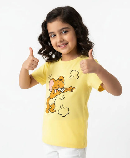 Child wearing a yellow t-shirt with a cartoon character, giving a thumbs-up gesture on a white background