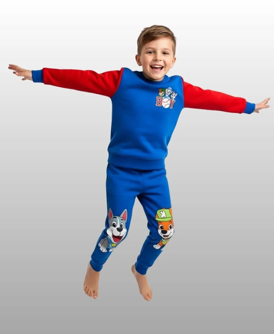Child wearing blue and red pajamas with cartoon characters on a gray background