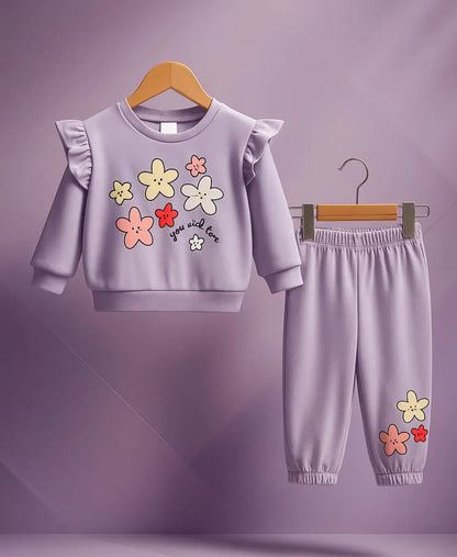 Children's outfit with floral design on a purple background