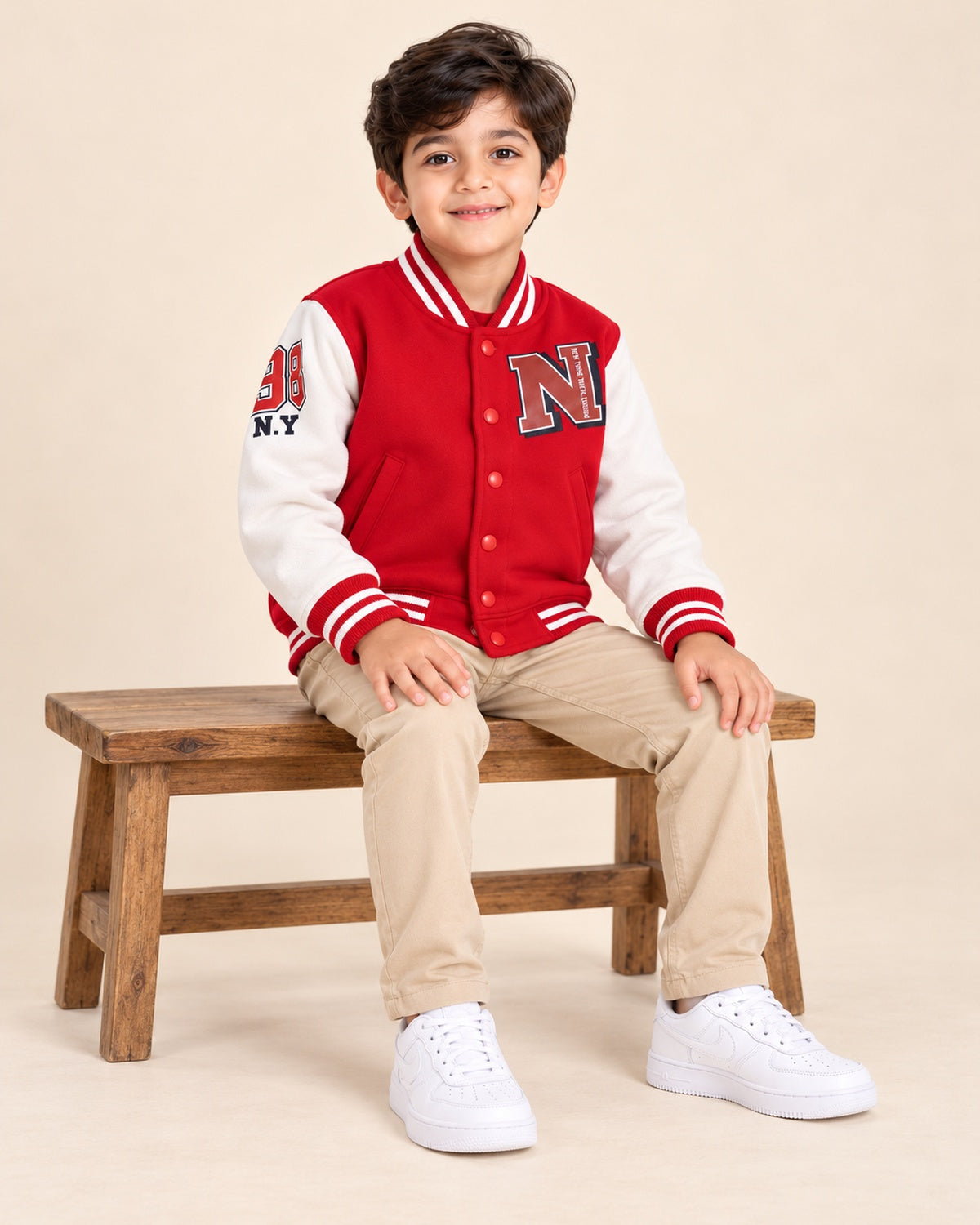 Happy Kidi red and white kids varsity jacket - AI styled seated view