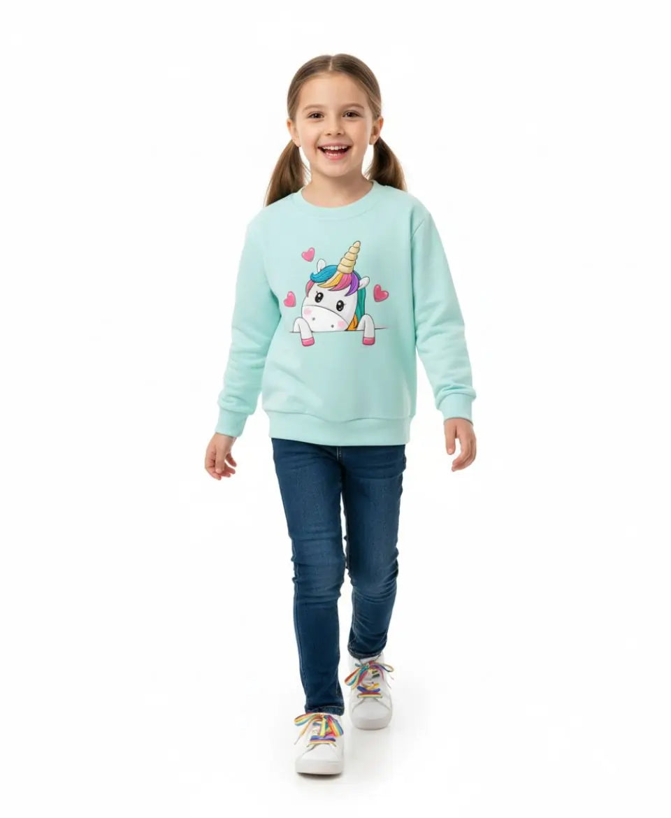 Child wearing a light blue sweatshirt with a unicorn design on a white background