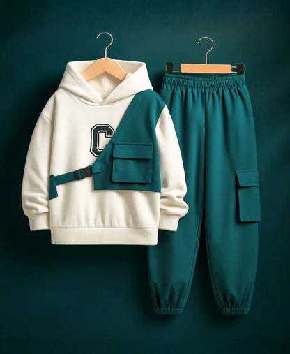 White hoodie with teal accents and matching pants on hangers against a dark background