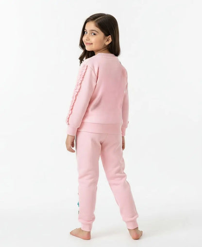 Young girl wearing a pink outfit on a white background