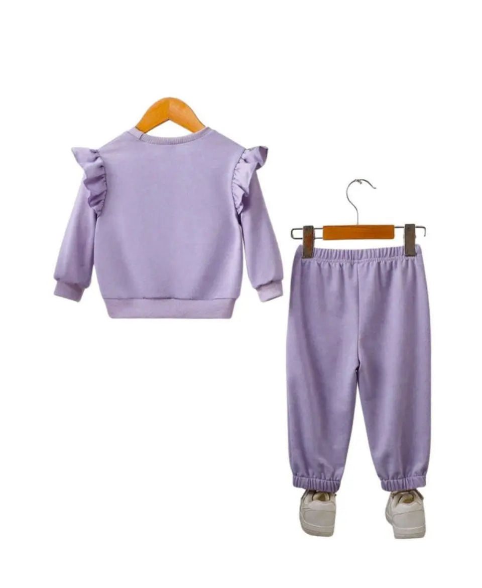 Purple children's outfit with ruffled sleeves on a white background