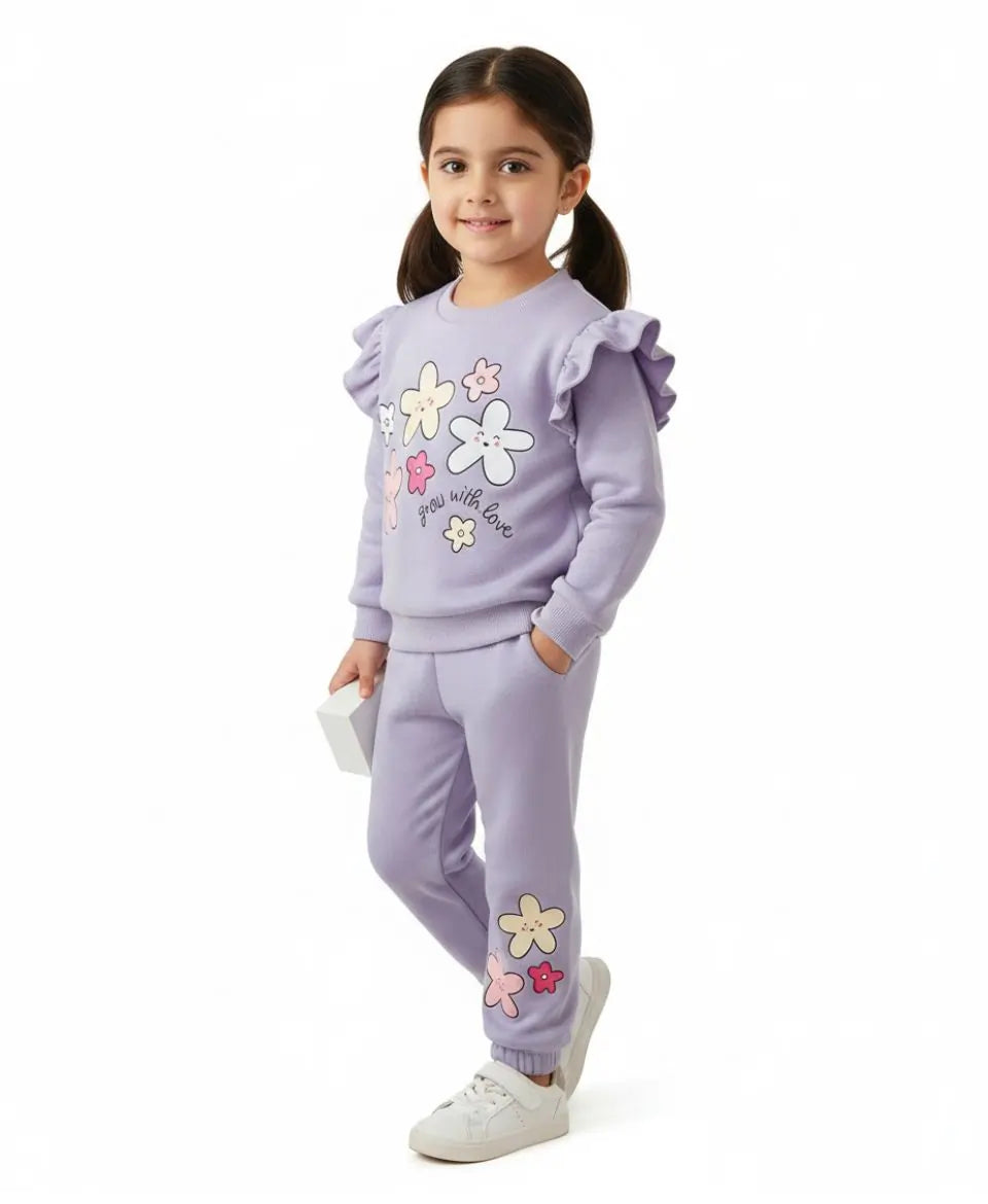 Young girl wearing a lavender outfit with floral designs on a white background