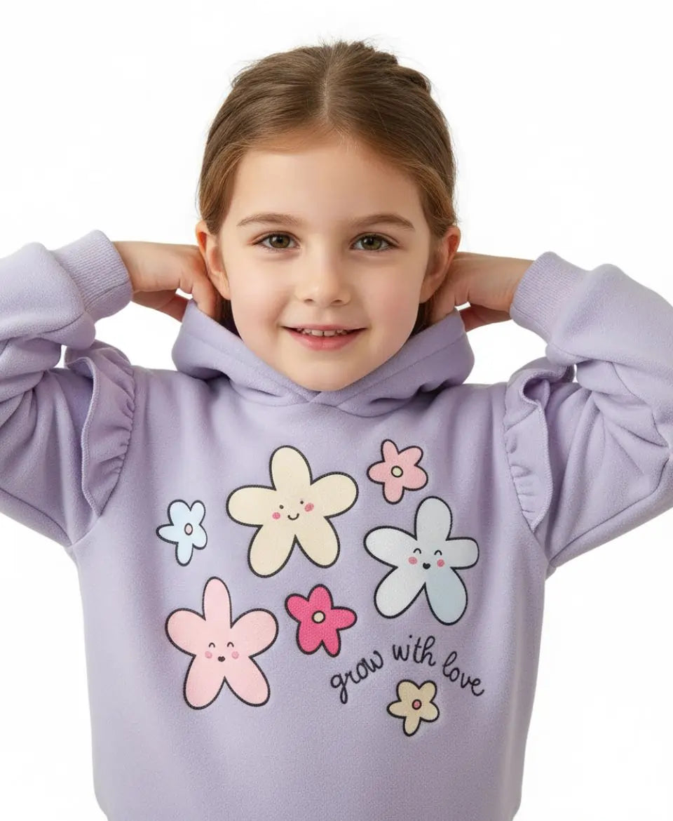 Young girl wearing a purple hoodie with flower designs and text on a white background