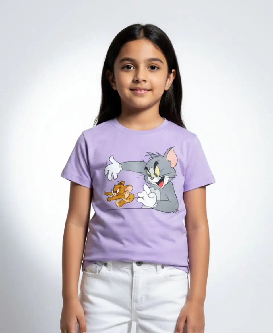 Young girl wearing a purple t-shirt with cartoon characters on a white background