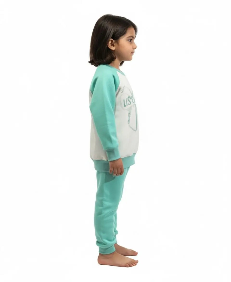 Child wearing a teal and white pajama set on a white background